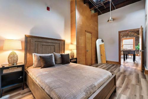 a bedroom with a large bed and a table at Soaring Designer Ceiling Condo near Market Square in Knoxville