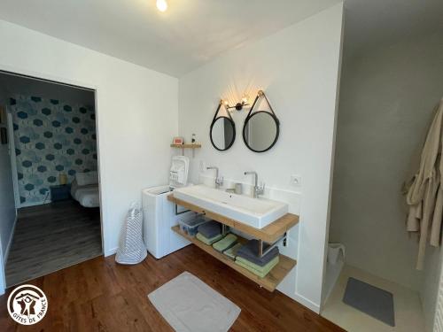 a bathroom with a sink and a mirror on the wall at Charmant gîte rural proche du Puy du Fou - FR-1-426-593 in Les Essarts