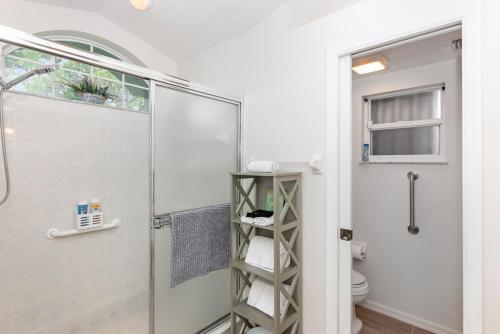 a bathroom with a shower and a toilet at Spacious Luxury Pool Home Oasis - 8mi to Airport in Palm Bay