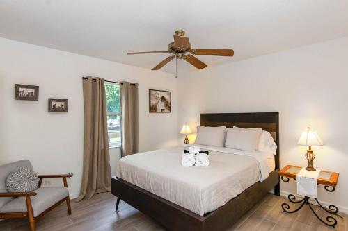 a bedroom with a bed and a ceiling fan at Spacious Luxury Pool Home Oasis - 8mi to Airport in Palm Bay
