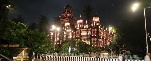 a building lit up at night with lights on at Sunlight Dormitory in Mumbai