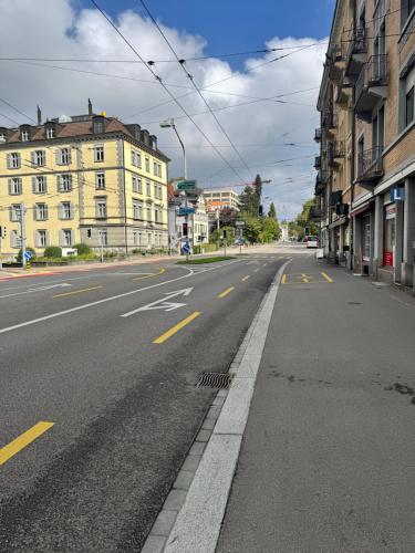an empty street in a city with buildings at Apartment im Zentrum St Gallen in St. Gallen