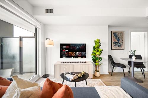 a living room with a couch and a table at City Living Downtown Retreat Perfect Getaway in Toronto