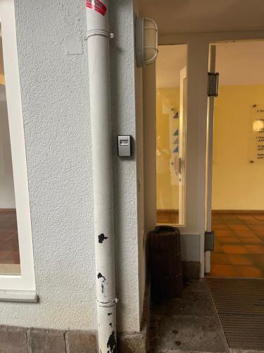 a white pole on the side of a building at Helles Studio mit Terrasse nahe Therme und Park in Bad Säckingen