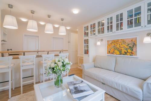 a living room with a couch and a table at Revelton Suites Karlovy Vary in Karlovy Vary