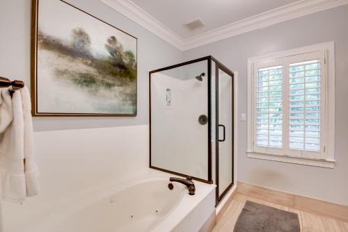 Baño blanco con bañera y espejo en Stunning Lake Oconee Retreat with Pool Access!, en Turnwold