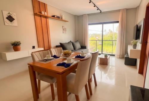 een eetkamer met een tafel en stoelen bij Apto com Piscina e Churrasqueira Perto da Praia in São Bento