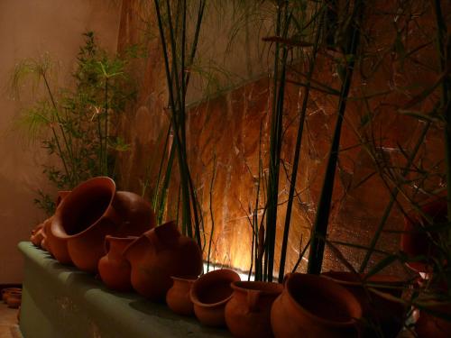 a row of clay pots sitting on a table at Gregorio I Hotel Boutique in San Salvador de Jujuy
