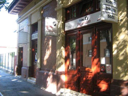 a building on the side of a street at Hostel Paparazzo & Apartmens in Kikinda