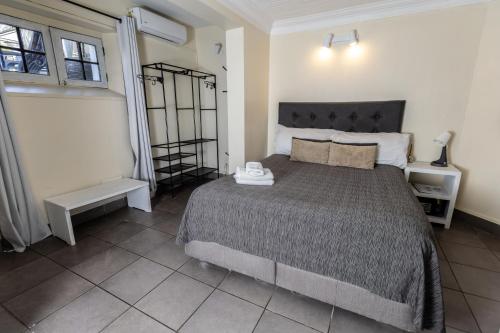a bedroom with a large bed in a room at De Blasis Budget Rooms in Santiago