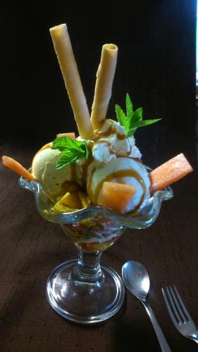 a glass bowl filled with ice cream and french fries at Steakhouse Fieg in Fuschl am See