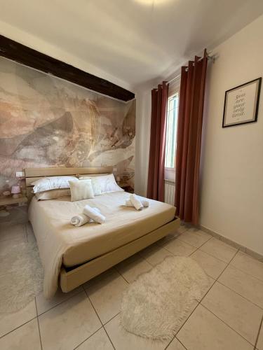 a bedroom with a bed with two towels on it at Nel centro storico di Ovada in Ovada