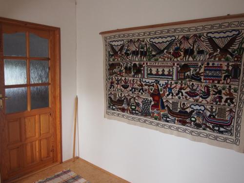 a tapestry hanging on a wall next to a door at Kopaniny in Kopaniny