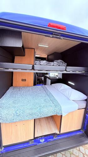 a bed in the back of a van at Caravana Poço Bispo in Lisbon