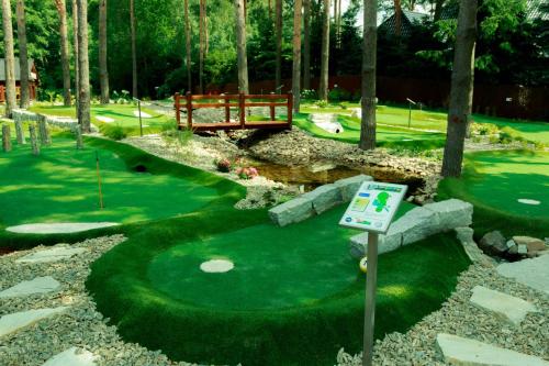 a miniature golf course with a sign in the grass at An-Son Apartamenty in Zielona Góra