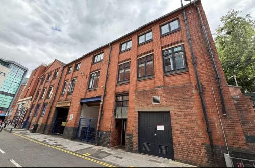 a red brick building on the side of a street at New City Centre Flat No 2 2 Bedroom Free Parking in Leicester