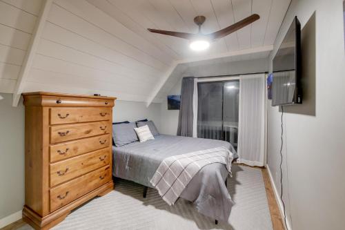 a bedroom with a bed and a dresser and a tv at Waterfront Escape with Hot tub and Dock in Eatonton! in Resseaus Crossroads