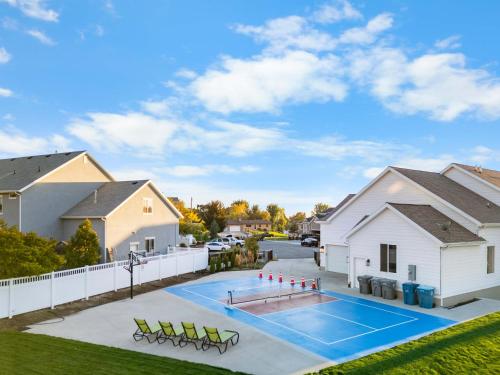 a swimming pool in a backyard with a house at Luxe Family Retreat with Private Pickleball a Large Swim Spa indoor Movie Theatre 2 Outdoor Firepits a Home Gym and more in Lindon