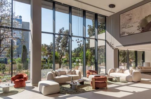 a lobby with white furniture and large windows at Hotel Sumratin in Dubrovnik