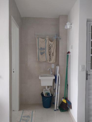 a bathroom with a sink and towels hanging on the wall at WK Flat em Porto de Galinhas in Porto De Galinhas
