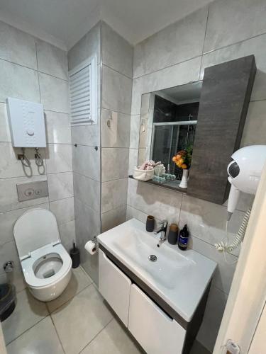 a bathroom with a white toilet and a sink at kestel city in Alanya