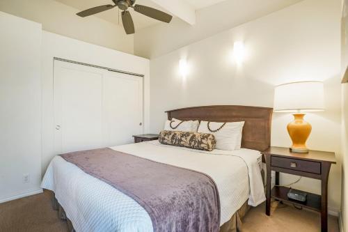 a bedroom with a bed and a ceiling fan at Kauai Kailani 319 in Waipouli
