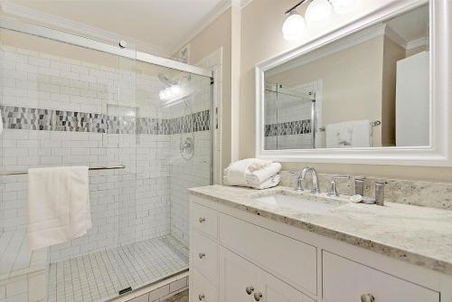 a white bathroom with a sink and a mirror at SG6A: 6A Seagrove Villa in Isle of Palms