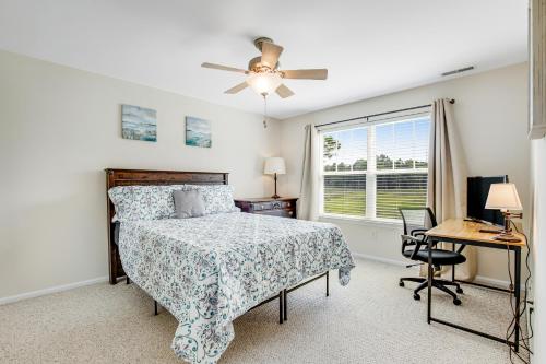 a bedroom with a bed and a desk and a window at Bethany Bay - 8004 Pettinaro Dr in Cedar Shores