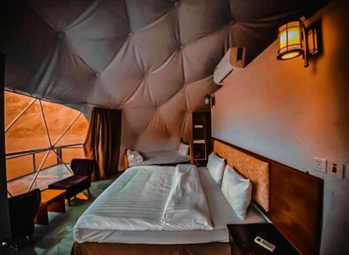 a bedroom with a large bed in a tent at Sama Wadi Rum Luxury Camp in Wadi Rum