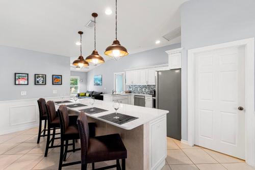 a kitchen with a large island with bar chairs at Barfield Bay Tuckaway in Rookery Island