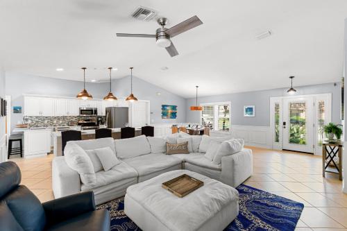a living room with a white couch and a kitchen at Barfield Bay Tuckaway in Rookery Island