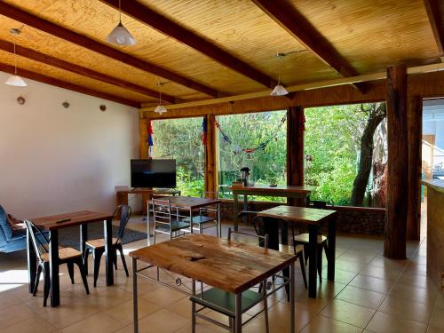 a dining room with tables and chairs and a tv at turisolcor atacama in San Pedro de Atacama