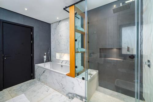 a bathroom with a shower and a tub and a toilet at Villa Anzar Refined Oasis wChef and Emerald Hammam in El Rhechat