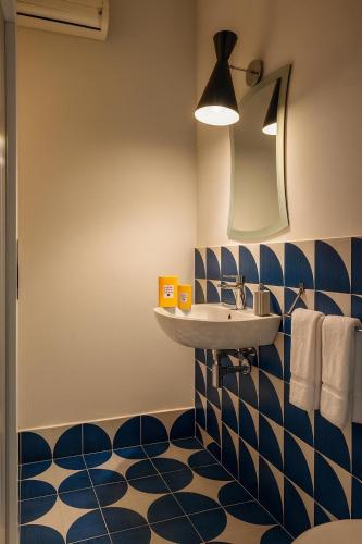 a bathroom with a sink and a blue and white floor at CAPRI DESIGN ROOM in Capri