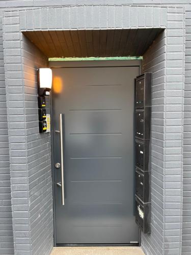a garage door in a brick wall with a parking meter at Sweet Home Appartements 2 in Bottrop