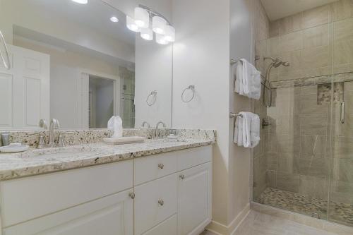a white bathroom with two sinks and a shower at SM04: 4 Silver Moss in Kiawah Island
