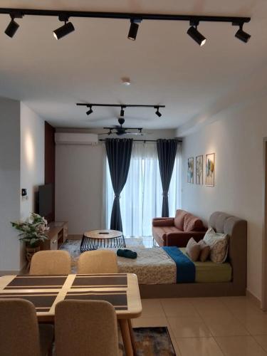 a living room with a bed and a couch at Delta1710 Chillax D'Alanis, KLIA in Sepang