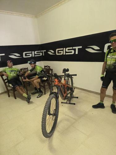a man standing next to a bike in a room at Tenuta Lo Cuoccio in Gravina in Puglia