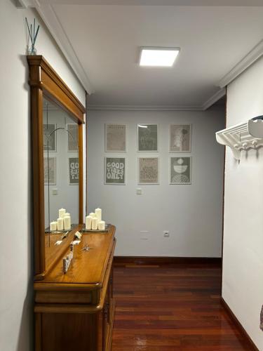 a bathroom with a mirror and a wooden counter at Vivienda vacacional: Los Abuelos in San Vicente de la Barquera