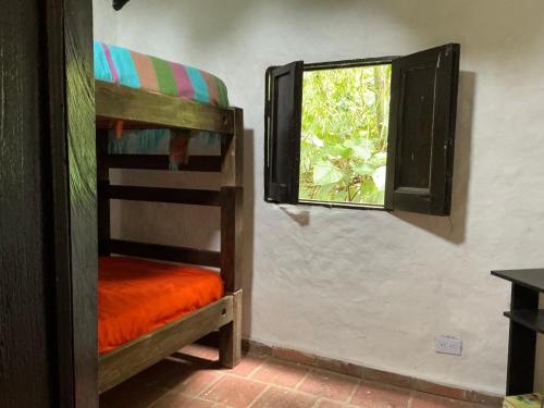a room with two bunk beds and a window at Luna Munay Hostel in Curití