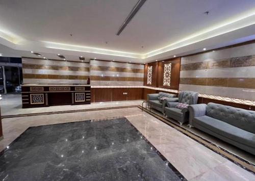 a lobby with couches and a bar in a building at فندق شركة وردة الوادي توصيل من والي الحرم 24 مجاني in An Naqāʼ