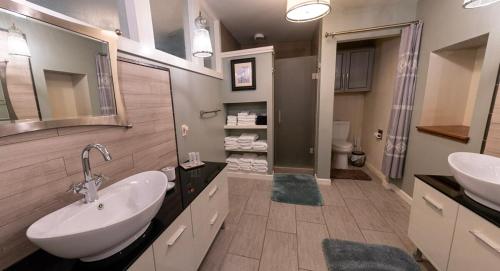 a large bathroom with two sinks and a mirror at Luxury spacious home, free parking, private patios in Eureka Springs