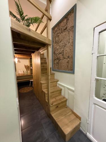 a wooden staircase in a room with a wall at Vacacionales Vegueta in Las Palmas de Gran Canaria