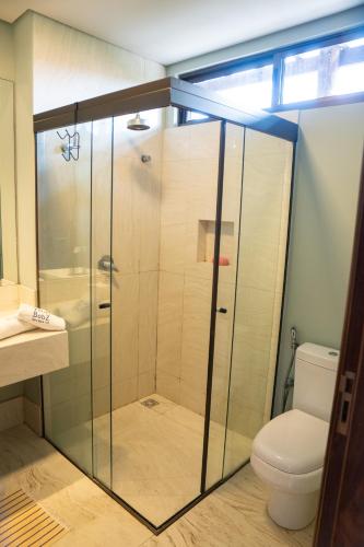 a glass shower in a bathroom with a toilet at Villas BobZ Ap 110 in Barrinha