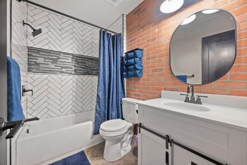 a bathroom with a sink toilet and a mirror at Modern 2 Bedroom Home with Fire Pit, Bikes in Portsmouth