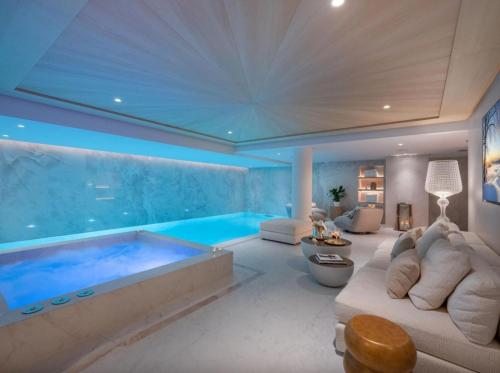 a large living room with a large swimming pool at Chalet Rte Brigues Courchevel in Courchevel