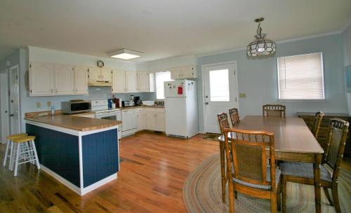 a kitchen with a table and a white refrigerator at Belvedere in Edisto Island