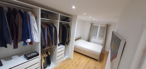 a walk in closet with a bed in it at Superbe logement au style Londonien Avec Cinema Ideal pour des grandes familles et professionnels in Drancy