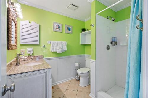 a bathroom with green walls and a toilet and a shower at SL912: 912 Sealoft in Seabrook Island