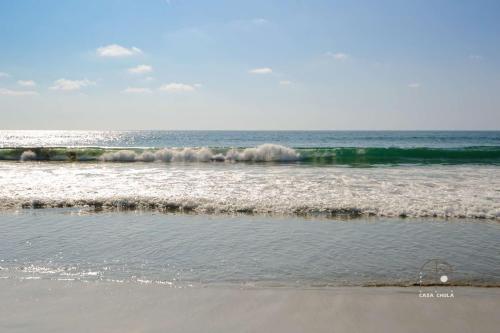 a view of the ocean with waves coming in at Beautiful Remodeled Studio In The Center La Punta in Brisas de Zicatela